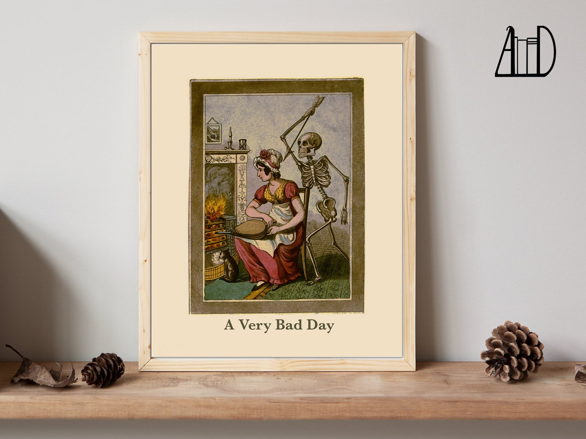 Drawing of a seated woman in front of a fireplace with a skeleton behind holding a raised spear. The words "A Very Bad Day" appear at they bottom. This art is in a frame sitting on a shelf. 